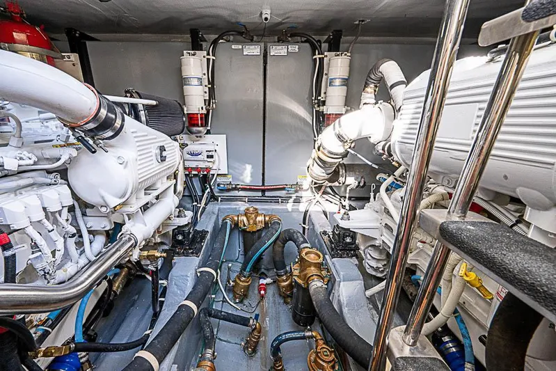  Yacht Photos Pics Engine room of 2017 Carver C52 Coupe yacht, showcasing complex machinery and piping.