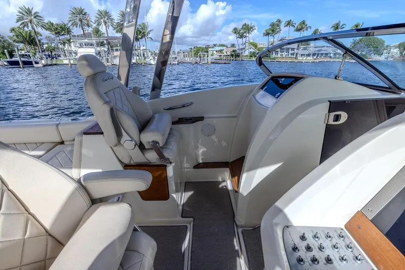 Ritz-sea Yacht Photos Pics 2019 Chris-Craft Calypso 30 interior with luxurious seating and helm, dockside view.