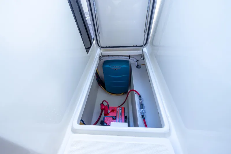 Ritz-sea Yacht Photos Pics 2019 Chris-Craft Calypso 30 storage compartment with battery and wiring.
