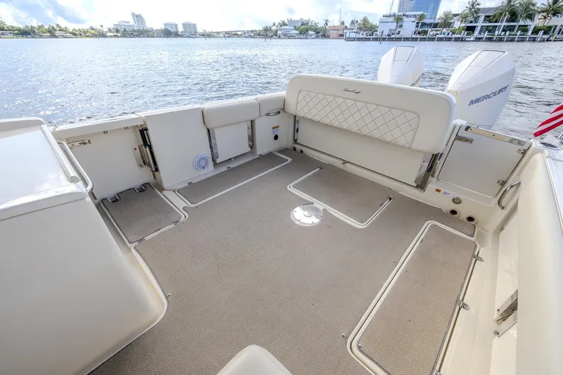 Ritz-sea Yacht Photos Pics 2019 Chris-Craft Calypso 30 boat deck with seating, overlooking water and cityscape.