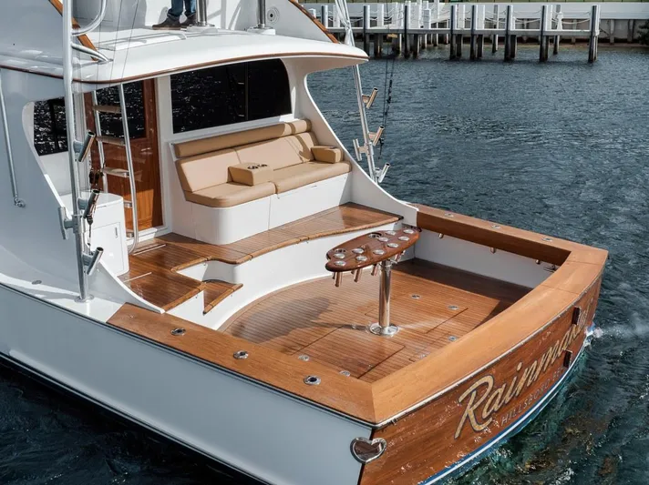 Rainmaker Yacht Photos Pics 2021 Garlington Convertible yacht with wooden deck and seating, docked at marina.