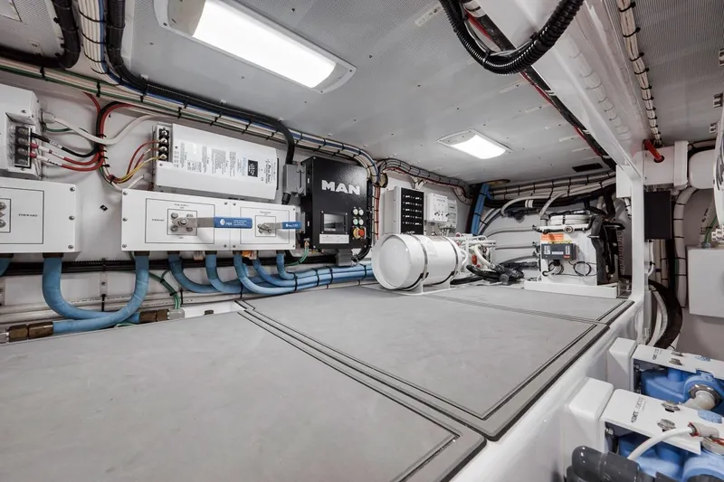 Rainmaker Yacht Photos Pics Engine room of a 2021 Garlington Convertible boat, featuring modern equipment and wiring.