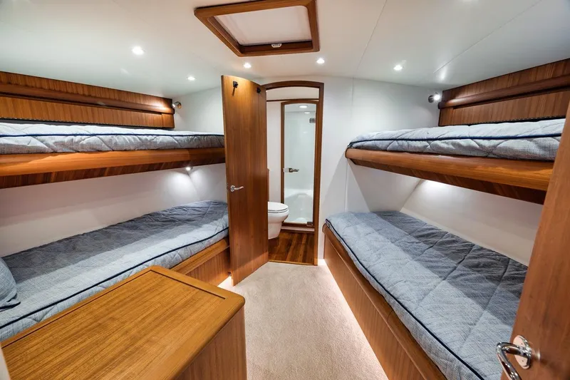 Rainmaker Yacht Photos Pics 2021 Garlington Convertible yacht interior with bunk beds and wooden finishes.