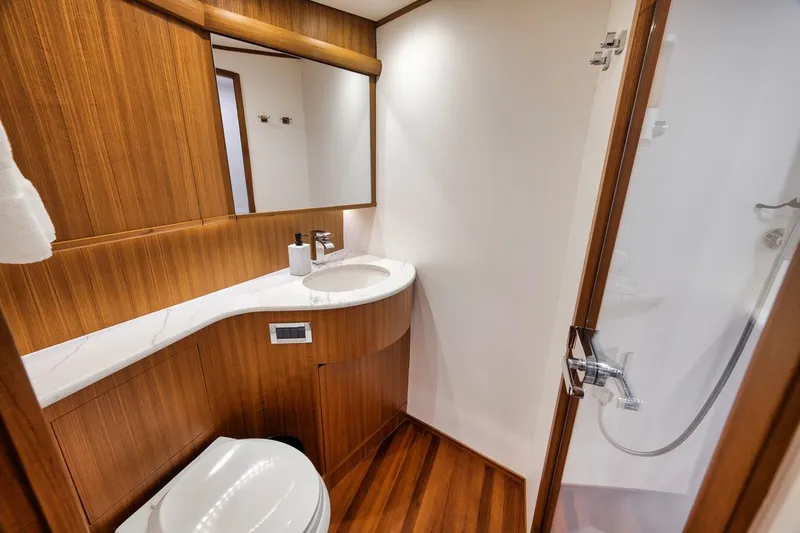 Rainmaker Yacht Photos Pics Luxurious 2021 Garlington Convertible yacht bathroom with wood accents and modern fixtures.