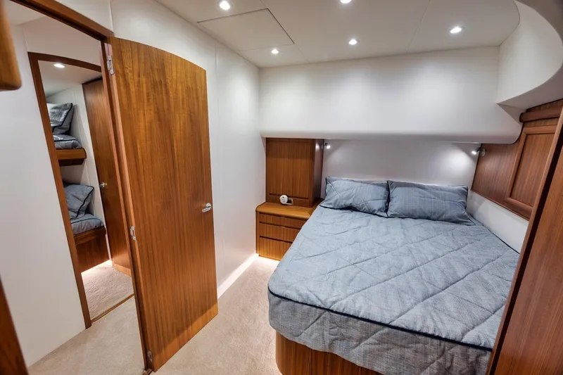 Rainmaker Yacht Photos Pics 2021 Garlington Convertible interior with cozy bedroom, wooden accents, and modern lighting.