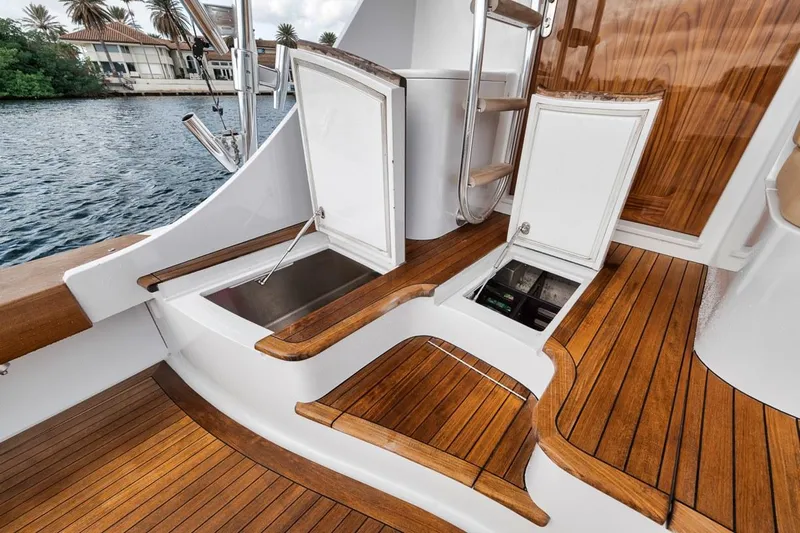 Rainmaker Yacht Photos Pics 2021 Garlington Convertible yacht deck with open storage compartments and wooden flooring.