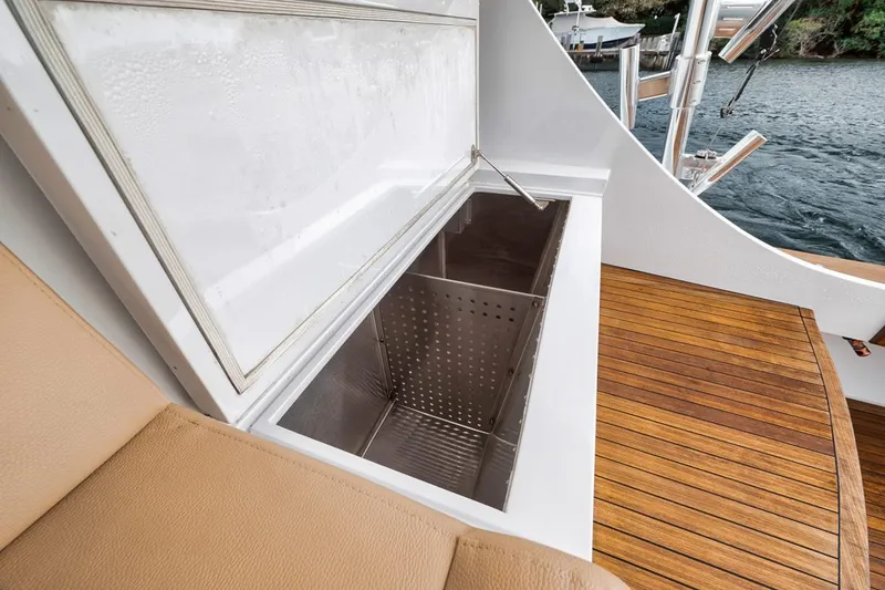 Rainmaker Yacht Photos Pics 2021 Garlington Convertible boat with open storage compartment and teak deck.