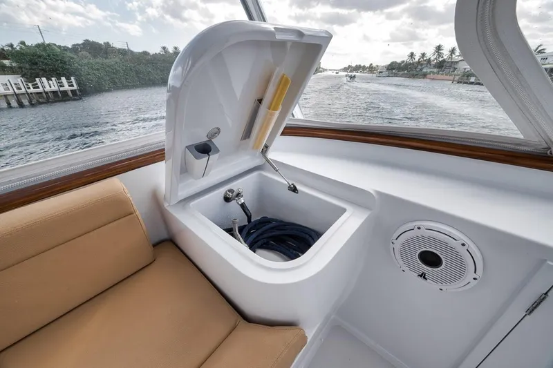 Rainmaker Yacht Photos Pics 2021 Garlington Convertible boat interior with storage compartment and speaker.