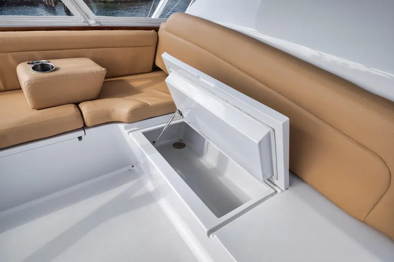 Rainmaker Yacht Photos Pics 2021 Garlington Convertible interior with tan seating and built-in storage compartment.