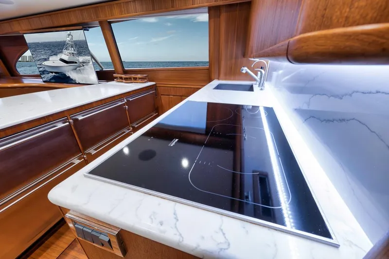 Rainmaker Yacht Photos Pics Luxurious 2021 Garlington Convertible yacht interior with modern kitchen and ocean view.