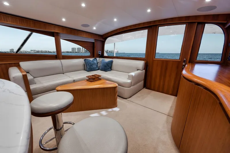 Rainmaker Yacht Photos Pics Luxurious interior of 2021 Garlington Convertible yacht with plush seating and ocean view.