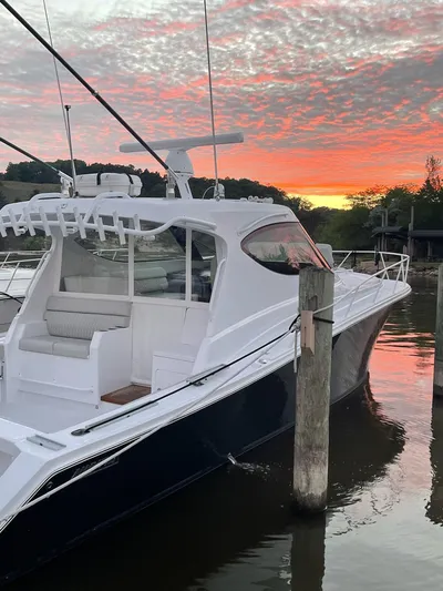  Yacht Photos Pics Jupiter 41 SB 2021 boat docked at sunset with vibrant sky.