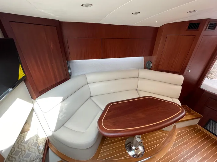  Yacht Photos Pics Luxurious interior of 2021 Jupiter 41 SB yacht with elegant seating and wooden table.