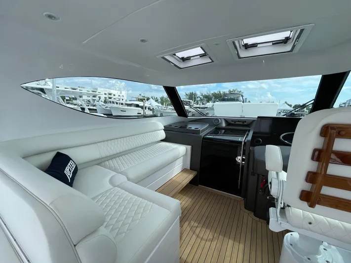  Yacht Photos Pics Luxurious interior of 2021 Jupiter 41 SB yacht with white seating and wooden flooring.