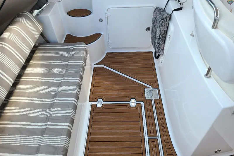  Yacht Photos Pics 2009 Regal Commodore 3760 IB boat interior with striped seating and wood-patterned flooring.