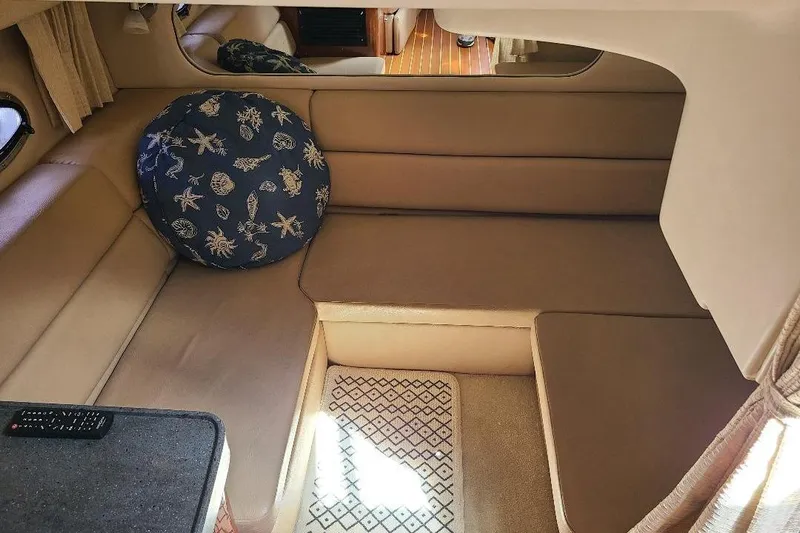  Yacht Photos Pics 2009 Regal Commodore 3760 IB cabin interior with beige seating and nautical-themed cushion.