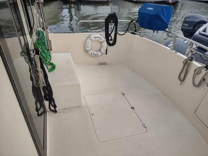 Snowy Owl Yacht Photos Pics Nordic Tug 42 boat deck, 2000 model, with ropes and life preserver.