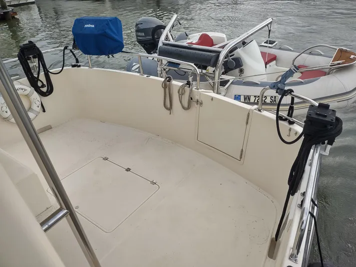 Snowy Owl Yacht Photos Pics Nordic Tug 42 boat deck, 2000 model, with dinghy in water.