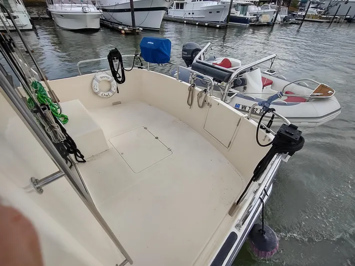 Snowy Owl Yacht Photos Pics Nordic Tug 42 (2000) boat deck with lifebuoy and moored dinghy.