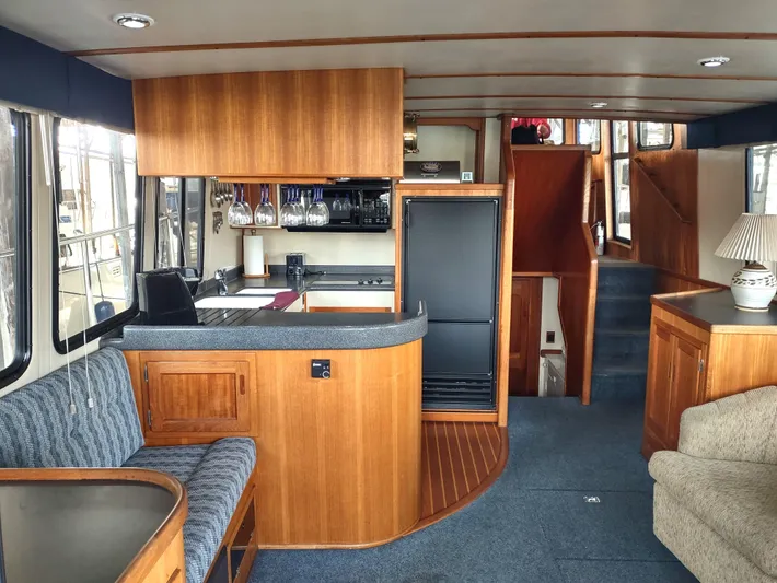 Snowy Owl Yacht Photos Pics Interior of 2000 Nordic Tug 42 with wood cabinetry and cozy seating area.