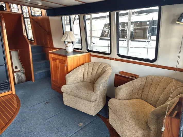 Snowy Owl Yacht Photos Pics Interior of 2000 Nordic Tug 42 with cozy seating and nautical decor.