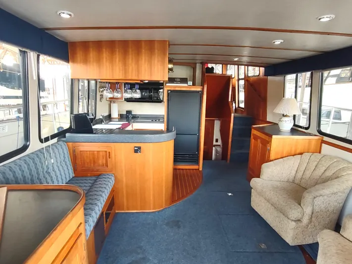 Snowy Owl Yacht Photos Pics Interior of 2000 Nordic Tug 42 with cozy seating and wooden cabinetry.