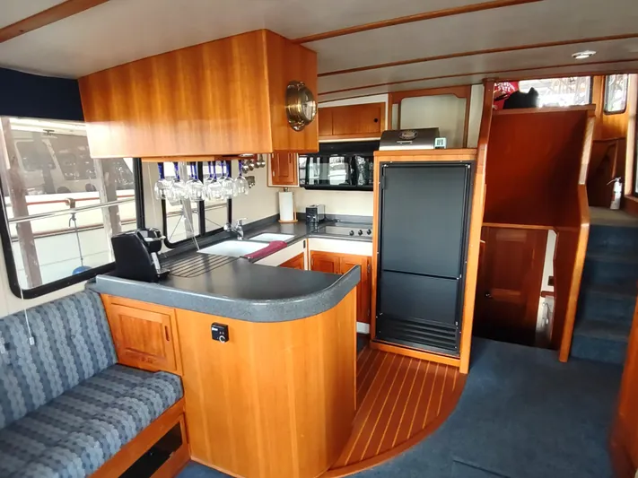 Snowy Owl Yacht Photos Pics Interior of 2000 Nordic Tug 42 with wood cabinetry and modern kitchen amenities.