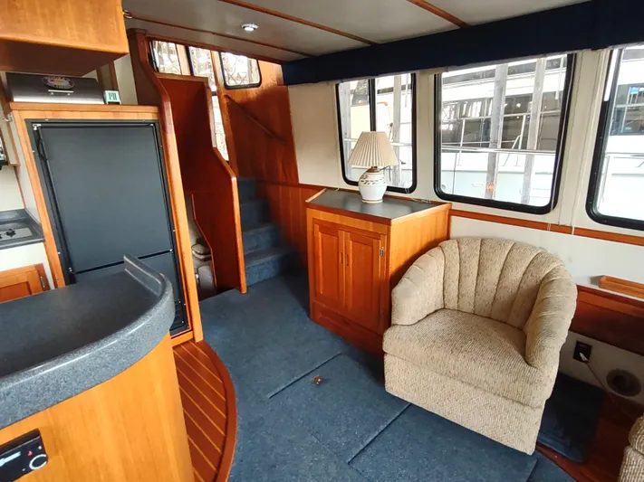 Snowy Owl Yacht Photos Pics Interior of 2000 Nordic Tug 42 with cozy seating and wooden cabinetry.