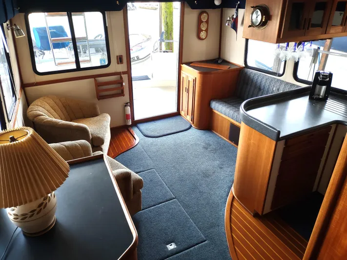 Snowy Owl Yacht Photos Pics Cozy interior of 2000 Nordic Tug 42 with wood accents and comfortable seating.