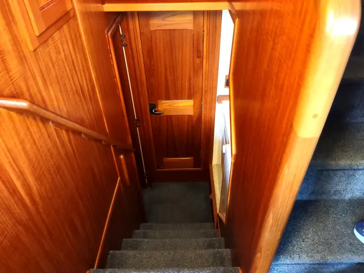 Snowy Owl Yacht Photos Pics Wooden staircase inside 2000 Nordic Tug 42 boat, leading to lower cabin area.