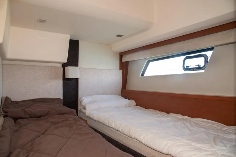  Yacht Photos Pics Interior cabin of 2013 Prestige 500 S yacht with twin beds and window.