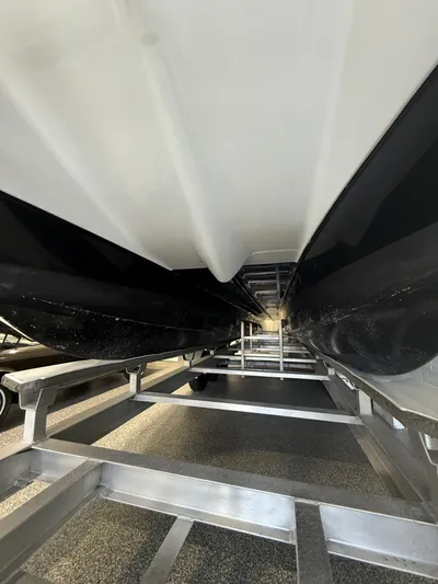  Yacht Photos Pics Underside view of 2023 World Cat 325 CC boat on a metal trailer.