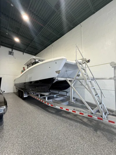  Yacht Photos Pics 2023 World Cat 325 CC boat on trailer in indoor storage facility.