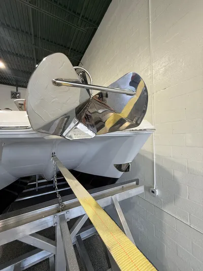  Yacht Photos Pics 2023 World Cat 325 CC boat with a shiny anchor in a showroom.