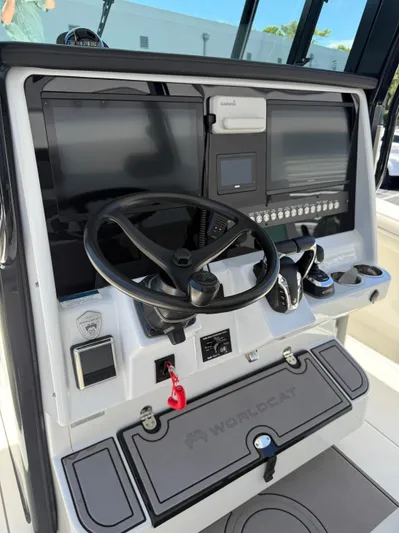 Yacht Photos Pics 2023 World Cat 325 CC boat dashboard with steering wheel and electronic displays.