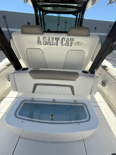  Yacht Photos Pics 2023 World Cat 325 CC boat interior with seating and storage compartment.