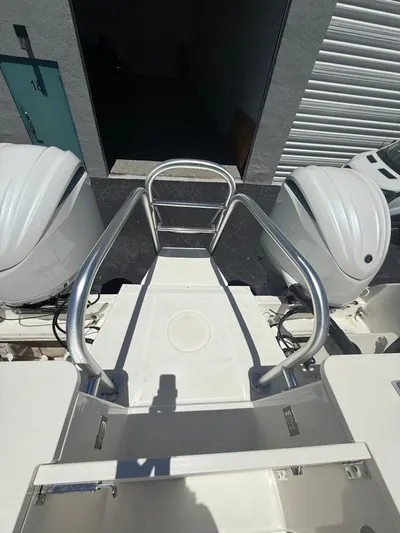  Yacht Photos Pics 2023 World Cat 325 CC boat with dual engines and metal railing, viewed from above.