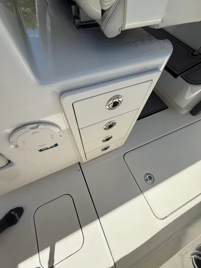  Yacht Photos Pics 2023 World Cat 325 CC boat interior with storage compartments and seating.