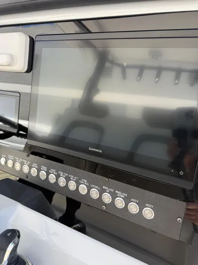  Yacht Photos Pics Control panel of 2023 World Cat 325 CC boat with Garmin display and multiple switches.