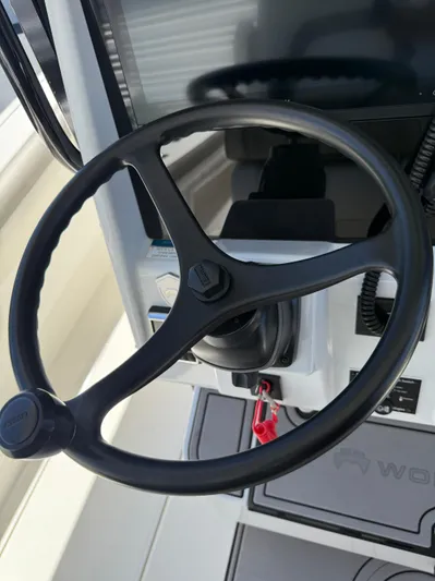  Yacht Photos Pics Steering wheel of 2023 World Cat 325 CC boat, featuring modern controls and dashboard.