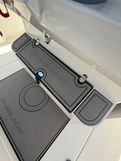  Yacht Photos Pics 2023 World Cat 325 CC boat deck with branded non-slip mat and storage compartment.