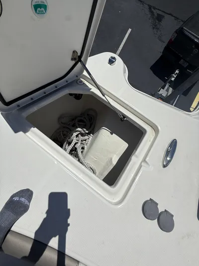  Yacht Photos Pics Open storage compartment on 2023 World Cat 325 CC boat, containing coiled rope.