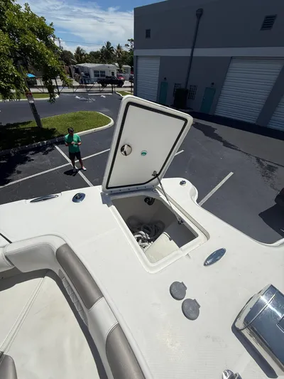  Yacht Photos Pics 2023 World Cat 325 CC boat with open storage compartment in a parking lot.