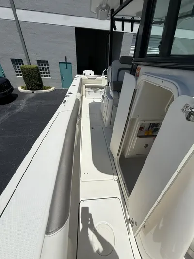  Yacht Photos Pics 2023 World Cat 325 CC boat interior, featuring sleek white seating and storage compartments.