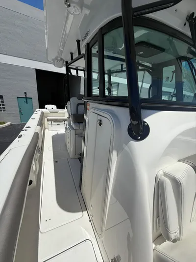  Yacht Photos Pics 2023 World Cat 325 CC boat, side view, showcasing sleek design and spacious deck.