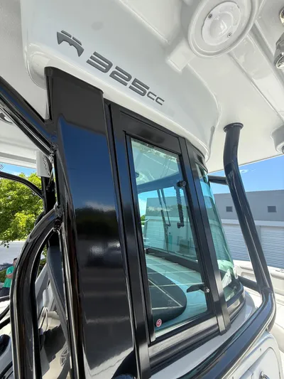  Yacht Photos Pics 2023 World Cat 325 CC boat, sleek black and white design, modern window features.