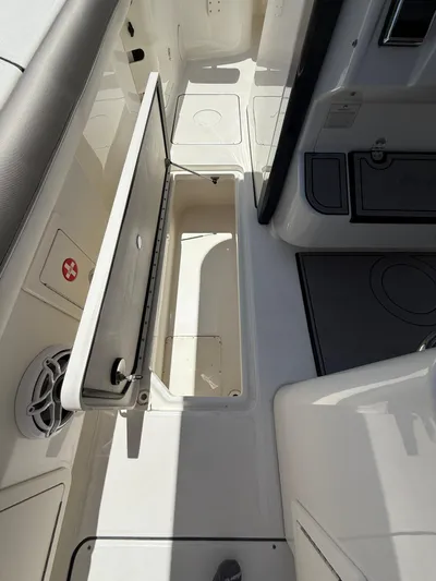  Yacht Photos Pics 2023 World Cat 325 CC boat interior with open storage compartment and seating area.
