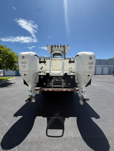  Yacht Photos Pics 2023 World Cat 325 CC boat with dual 300 V6 engines, parked under clear blue sky.