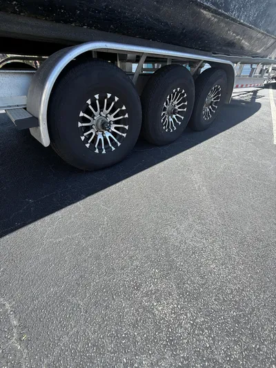  Yacht Photos Pics Triple-axle trailer with chrome wheels for 2023 World Cat 325 CC boat.