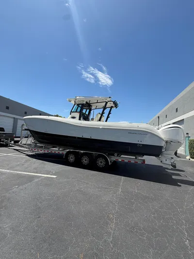  Yacht Photos Pics 2023 World Cat 325 CC boat on trailer under clear blue sky.